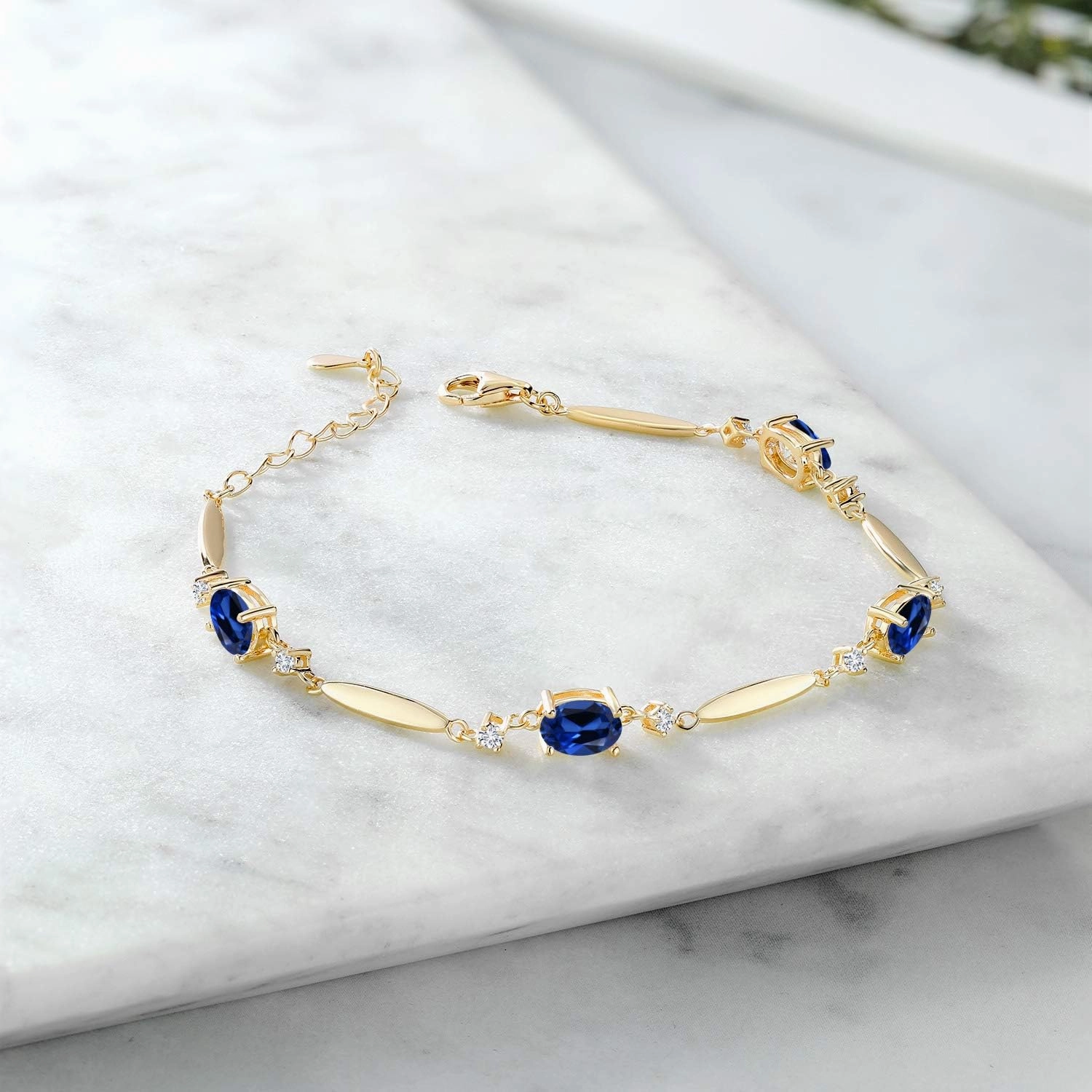 Gem Stone King 18K Yellow Gold Plated Silver Gemstone Birthstone and White Lab Grown Diamond Tennis Bracelet For Women | Oval 7X5MM and 2MM | 6 Inch   1 Inch Extender | Fine Jewelry for Her Mom Wife